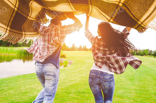 Preview: The happy couple running in a park in a sunny background