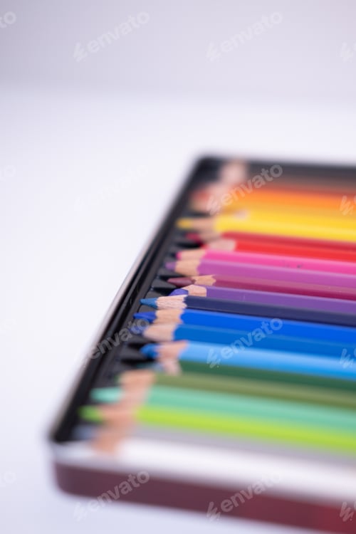 Preview: Colored pencils in a box on a white background. Selective focus. High quality photo
