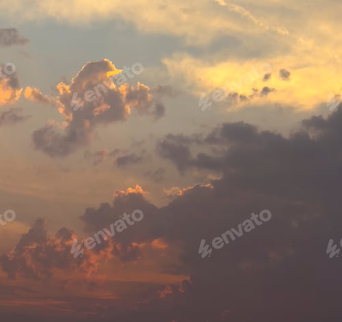 Preview: a picturesque sunset sky with wispy clouds illuminated by the golden light of the setting sun