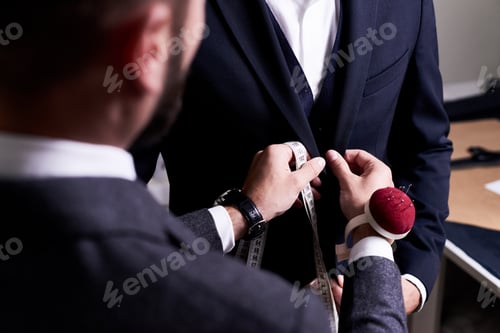 Preview: Tailor Fitting a Dark Suit in a Workshop