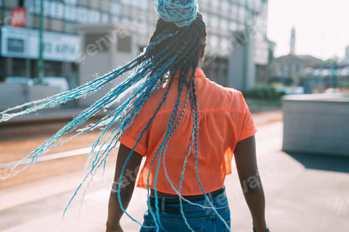 Preview: Rear view unrecognizable bblack woman with blue braid hair outdoor