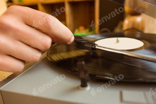 Preview: Young man putting on a vinyl at home in the living room