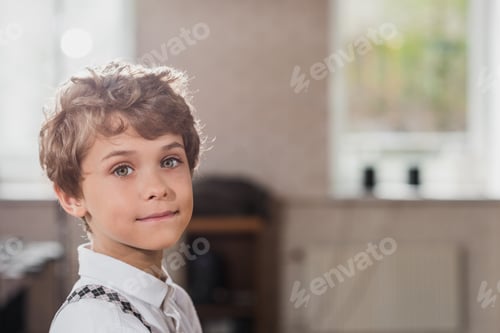 Preview: smiling little kid looking at camera at barbershop