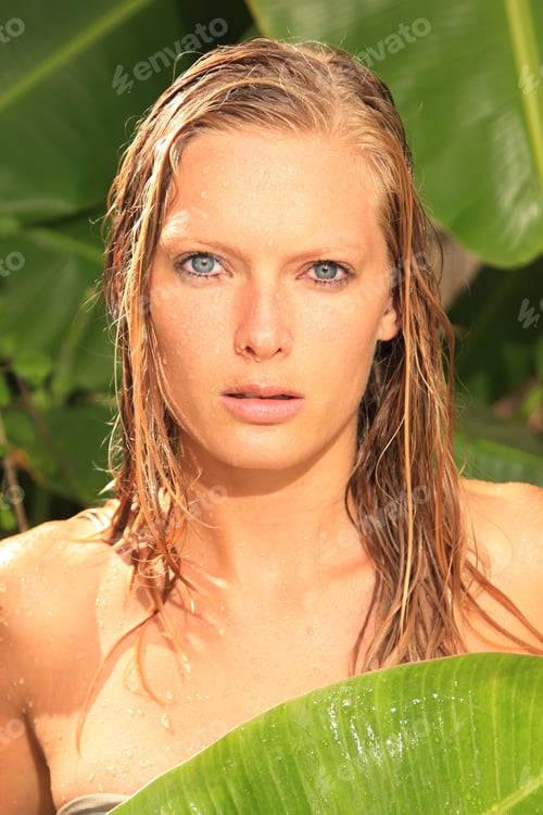 Preview: woman in tropical shower palms around