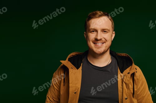 Preview: Handsome man showcases casual fashion in a vibrant studio setting