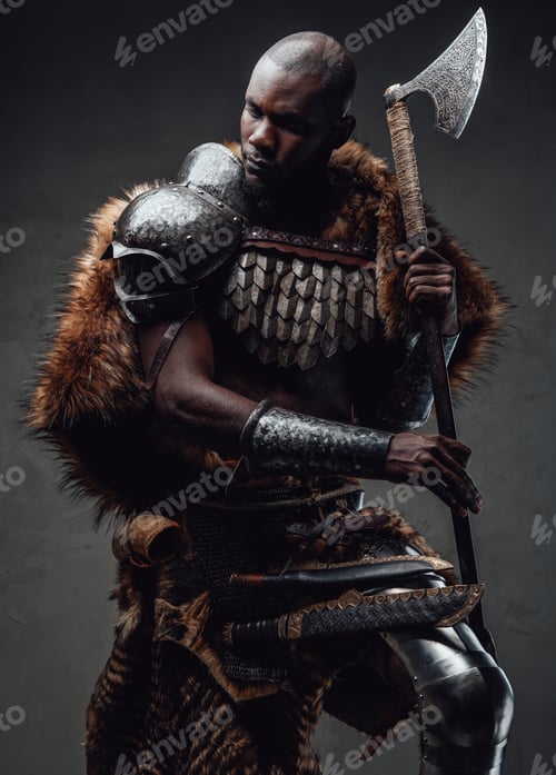 Preview: African guy dressed in military nordic costume holding an axe