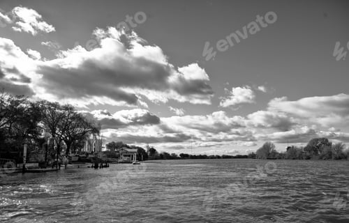 Preview: Black and white river landscape with dramatic clouds.
