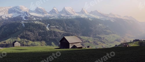 Preview: Cabin in a beautiful landscape surrounded by rocky mountains under a cloudy sky