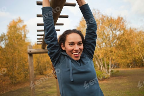 Preview: Young woman enjoying outdoor fitness on a sunny autumn day