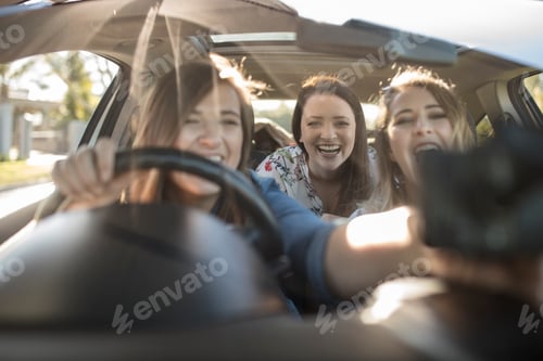 Preview: Friends laughing together on a car ride.
