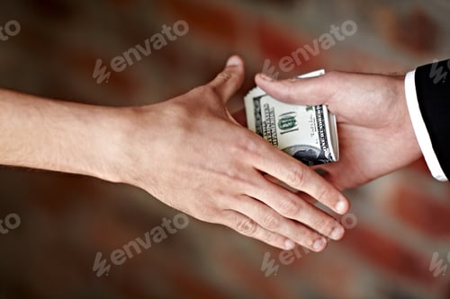 Preview: Receiving a bribe. Cropped shot of hands receiving an illegal payoff.