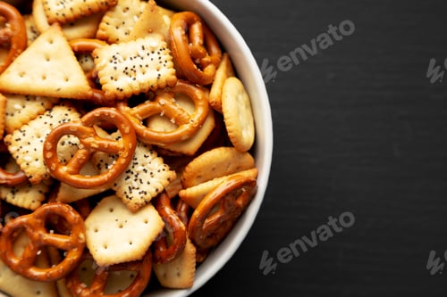 Preview: Homemade Cracker Snack Mix with Pretzels in a Bowl, top view. Copy space.
