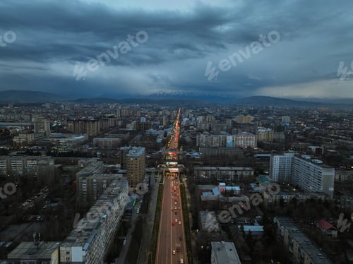 Preview: Evening aerial view of a busy illuminated city street and residential area