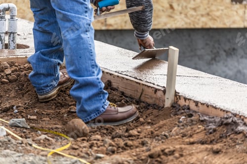 Preview: Construction Worker Using Wood Trowel On Wet Cement Forming Coping Around New Pool