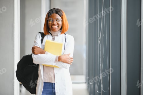 Preview: Medical Internship Concept. Portrait Of Young Black Female Doctor Student In White Coat