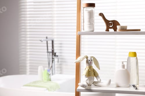 Preview: Baby accessories and bathing products on rack in bathroom. Space for text