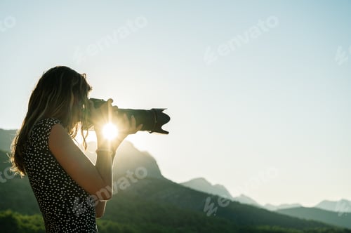 Preview: Young female photographer taking photos of beautiful nature