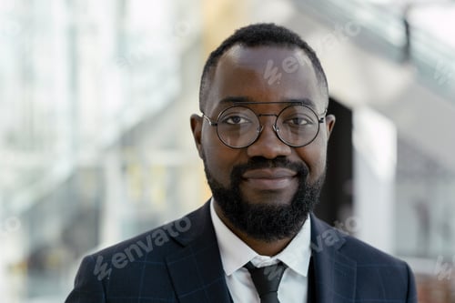 Preview: Young smiling man in eyeglasses and elegant suit