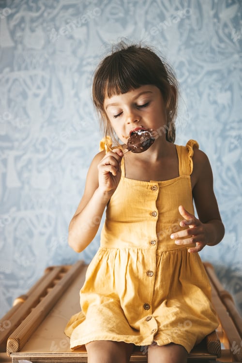 Preview: Little girl with closed eyes eating ice cream