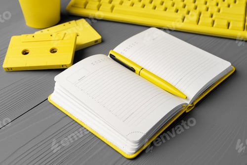 Preview: Yellow notepad on gray wooden background top view