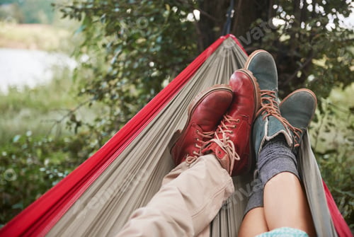 Preview: Feet of couple relaxing in hammock, Krakow, Malopolskie, Poland, Europe