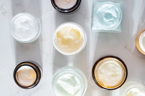 Preview: Cosmetics packaging. Set of different cosmetic jars of face cream, mask, balm on beige marble