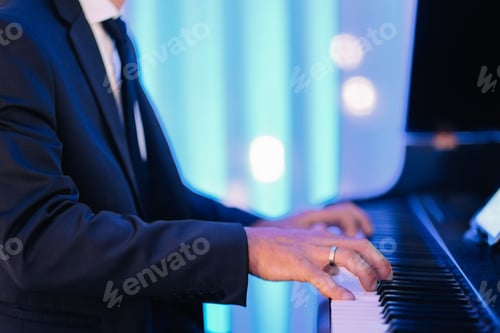 Preview: Shallow focus shot of a male pianist playing on a luxury event