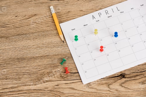 Preview: High angle view of pencil, office pins and calendar of april on wooden background