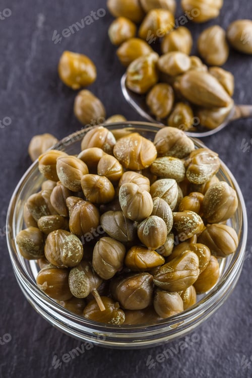 Preview: pickled capers on a dark stone background