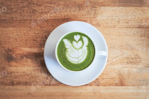Preview: Green tea matcha latte in a cup on wooden background