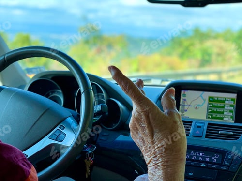 Preview: Hand of an elderly woman pointing to something that caught her attention during road trip