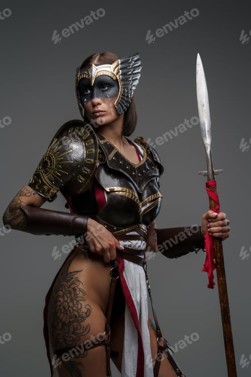 Preview: Wild woman warrior holding spear isolated on gray background