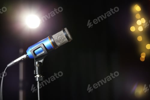 Preview: Stand with microphone on stage, space for text. Blurred lights