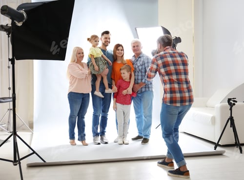 Preview: Professional photographer taking photo of family in studio
