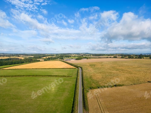 Preview: Aerial view of a road surrounded by agricultural farming fields in Eccup, Leeds, West Yorkshire