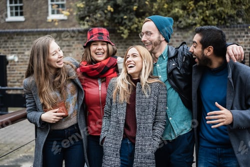 Preview: Group on friends having fun around the city in winter time - Focus in center girl face