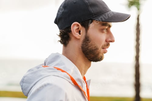 Preview: Focused unshaven sportsman looking forward while working out