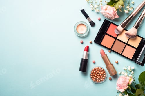 Preview: Cosmetic products on blue background with green leaves and flowers.