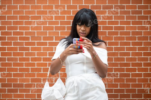 Preview: Black skinned woman using smartphone
