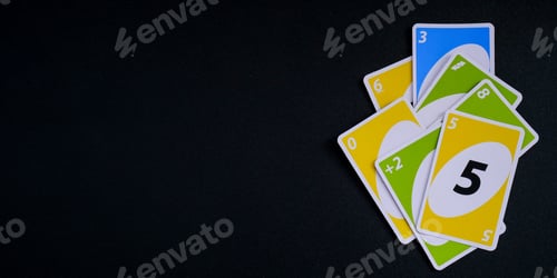 Preview: Playing cards UNO on black Table games. Pastime. Board games. Stay home leisure activity for kids