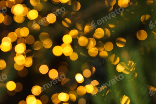 Preview: Blurred yellow lights and christmas branches, space for text
