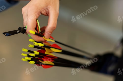 Preview: Close-up of a hand holding vibrant arrows.