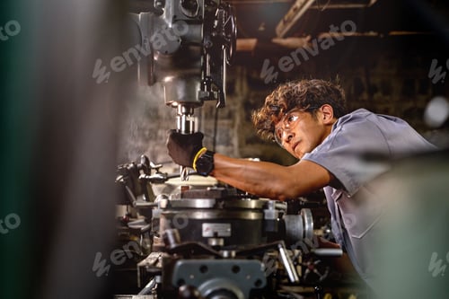 Preview: Men are inspecting steel parts for machine installation.