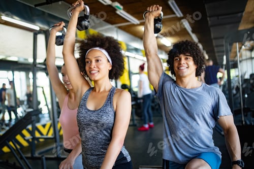 Preview: Group of sportive people in a gym training