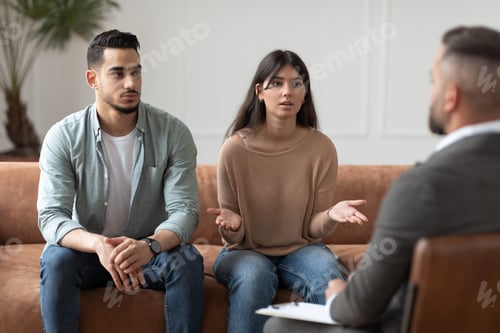 Preview: Couple talking at session with professional male therapist
