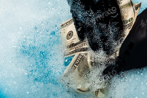 Preview: close up of man in rubber gloves washing dollar banknotes in soap bubbles with water