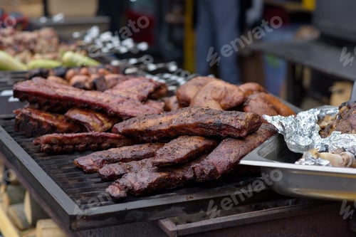 Preview: Grilled pork baby ribs with barbecue sauce on the grill. Festival street food