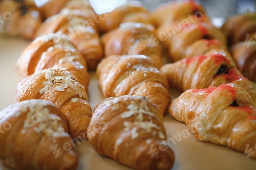 Preview: Croissants in a bakery. Cooking pastries in a pastry shop. French crispy croissants close up