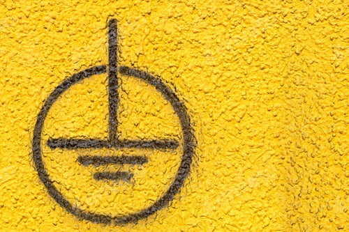 Preview: The Image Of A Black Sign Of Grounding On The Yellow Rough Plastered Wall For Industrial Backgrounds