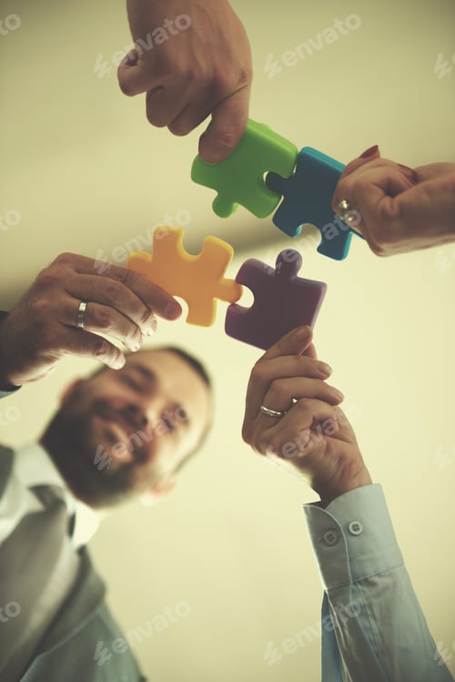 Preview: business people group assembling jigsaw puzzle